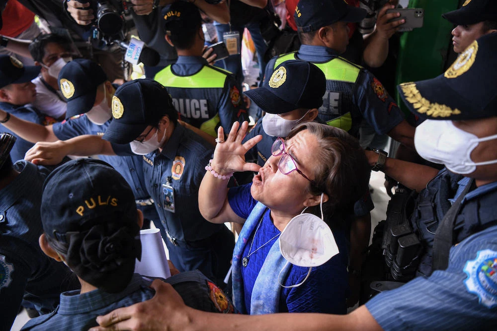 Former Philippine senator Leila de Lima, center, is accused of taking money from drug lords jailed inside the country’s largest prison to allow them to sell drugs while she was the justice minister from 2010 to 2015. (AFP)
