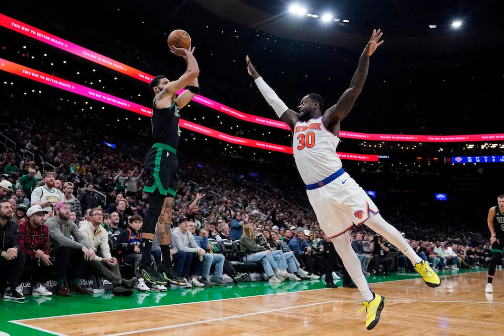 Boston Celtics forward Jayson Tatum, left, takes a shot over New York Knicks forward Julius Randle during the second half of an NBA basketball game Monday in Boston. (AP)