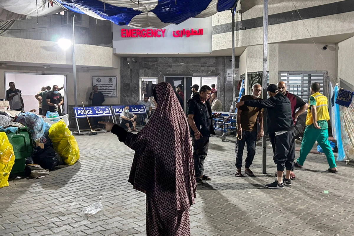 People stand outside the emergency ward of Al-Shifa hospital in Gaza City on November 10, 2023, amid ongoing battles between Israel and the Palestinian Hamas movement. (AFP)