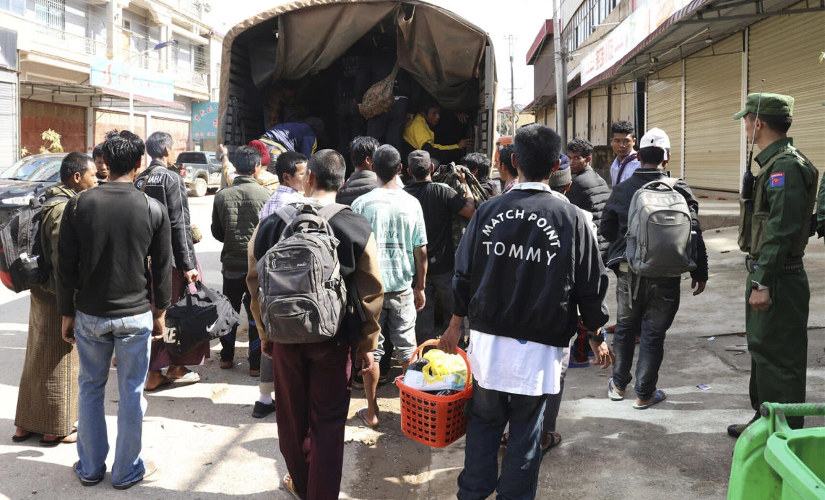 Above, members of the Myanmar National Democratic Alliance Army herd soldiers of the army battalion and their family members who surrendered to them in this Nov. 14, 2023 photo. (The Kokang online media via AP)