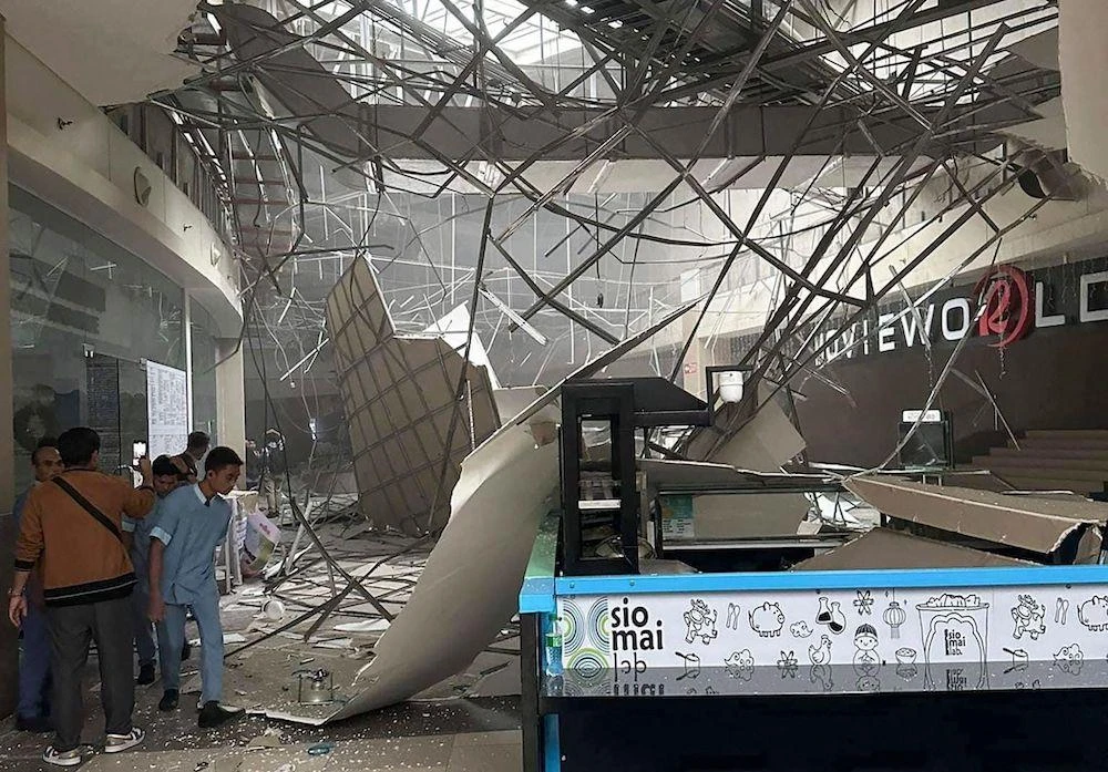 Above, a collapsed ceiling inside a shopping mall in General Santos City, less than 100 kilometers from the epicenter. (Shaira Ann Sandigan-Rodrigo via AFP)