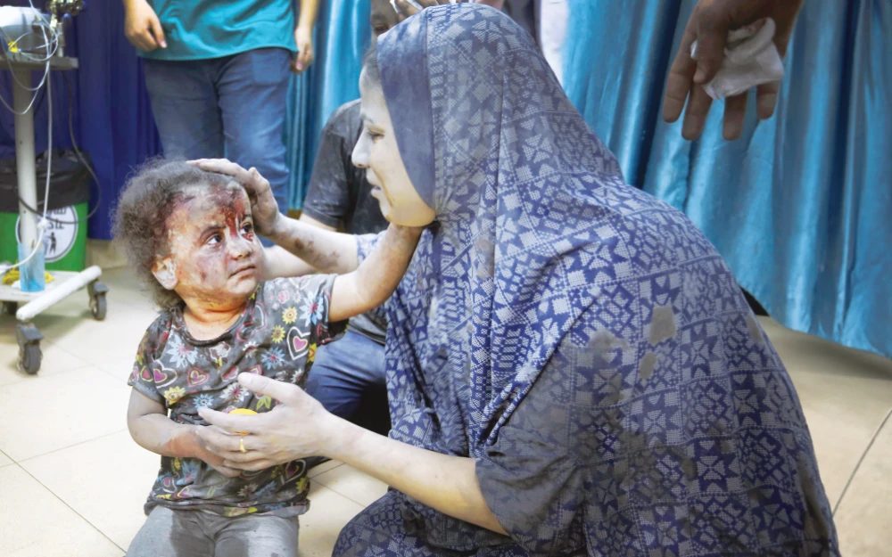 An injured child is brought to the Al-Aqsa Hospital after the Israeli attack. (Getty Images)