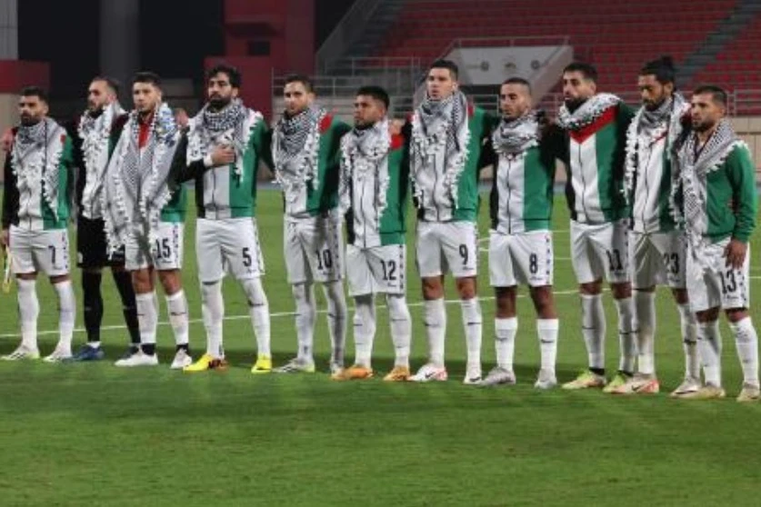 Palestine’s starting eleven gather for their national anthem ahead of their 2026 FIFA World Cup AFC qualifiers match against Lebanon at the Khalid Bin Mohamed Stadium in Sharjah on Nov. 16, 2023. (AFP)