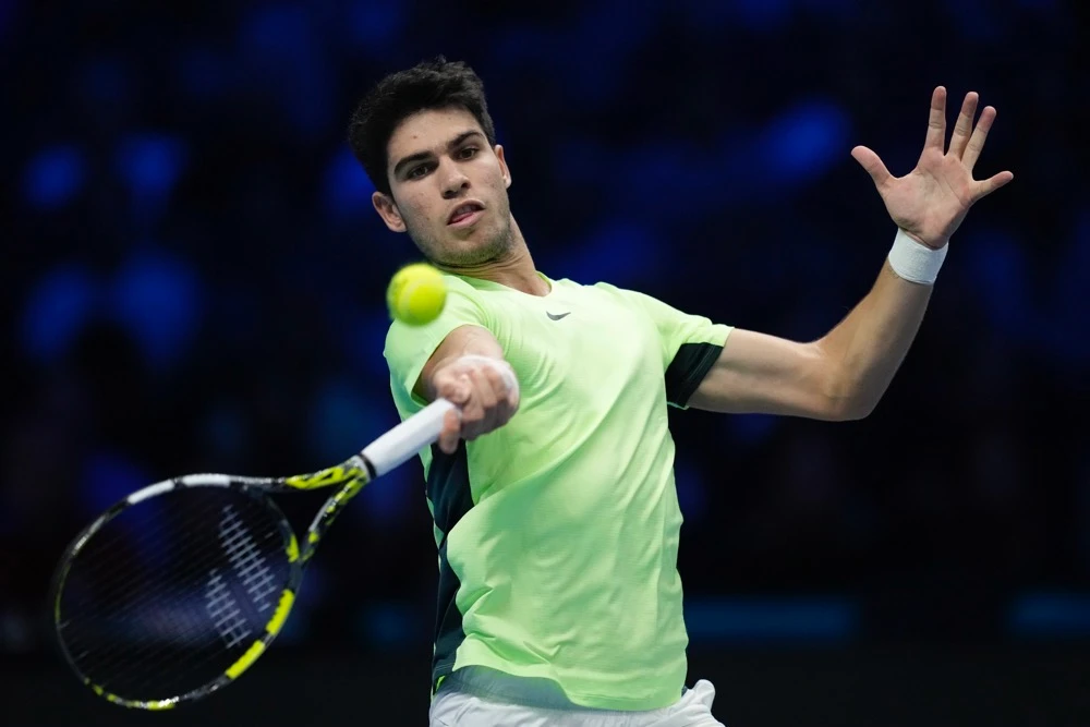 Spain's Carlos Alcaraz returns the ball to Russia's Daniil Medvedev during their singles tennis match of the ATP World Tour Finals at the Pala Alpitour in Turin Friday. (AP)