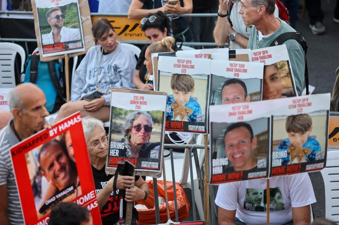 Family members, friends and supporters of hostages held in the Gaza Strip since the October 7 attack by Hamas militants in southern Israel, hold images of those taken during a protest calling for their release outside the Prime Minister's office in Jerusalem (AFP)