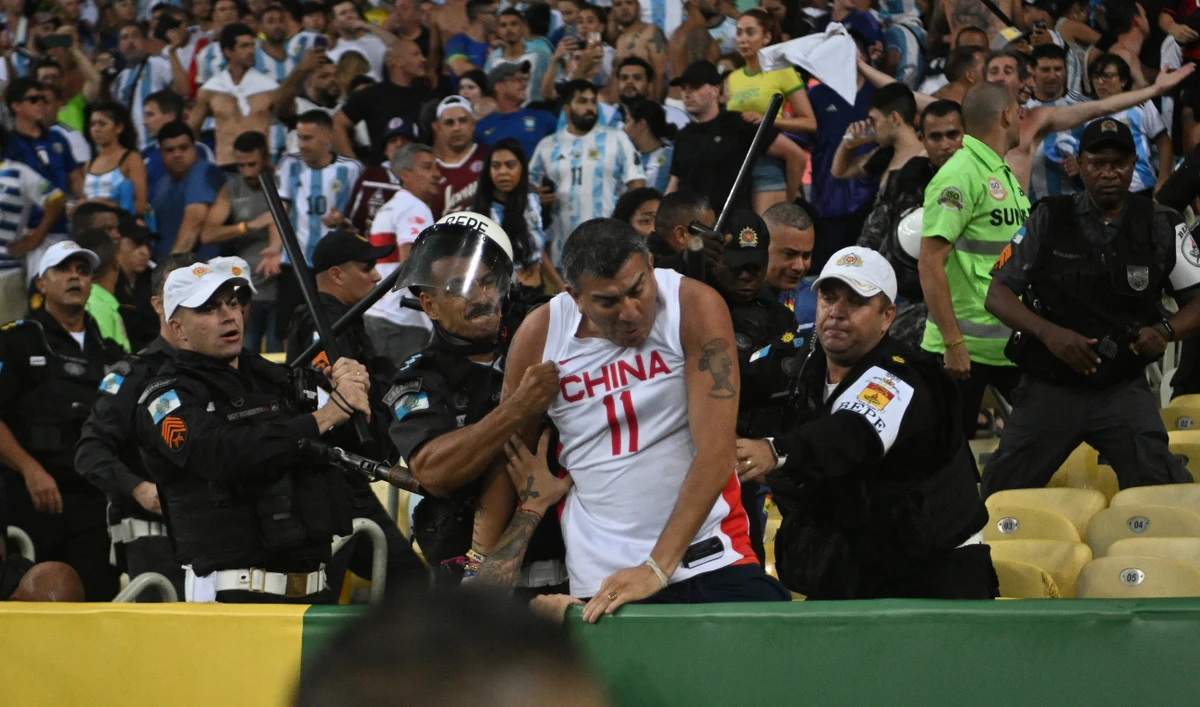 Fans of Argentina clash with Brazilian police before the start of the 2026 FIFA World Cup South American qualification football match between Brazil and Argentina at Maracana Stadium in Rio de Janeiro, Brazil, on November 21, 2023. (AFP)