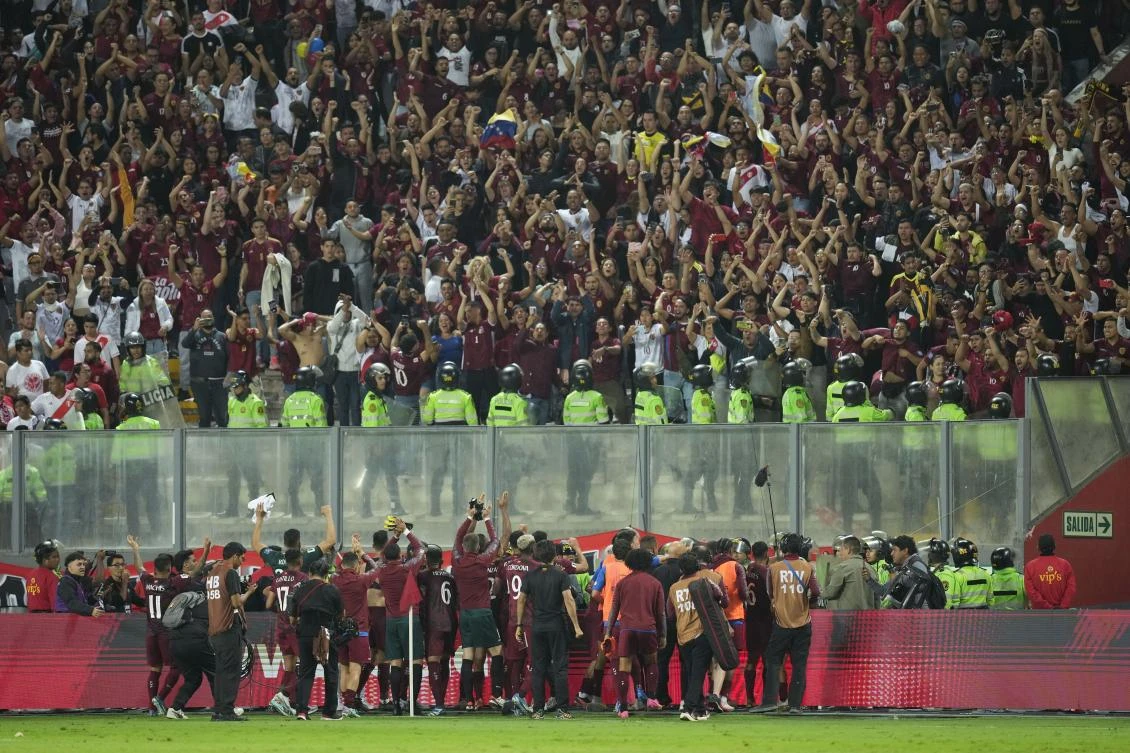 Venezuela players celebrate after draw with Peru 1-1 during a qualifying soccer match for the FIFA World Cup 2026 at the National stadium in Lima, Peru, on Nov. 21, 2023. (AP)