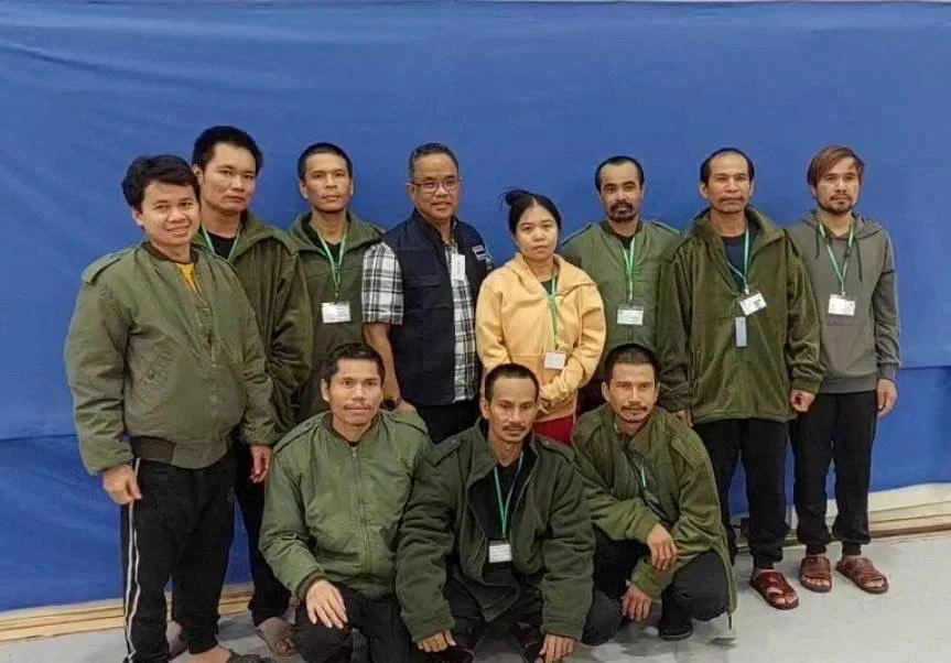 Thai workers taken hostage by Hamas and later released as part of a deal between Israel and Hamas, pose with a member of Thai mission after a medical checkup, in Tel Aviv, in this handout image released on Nov. 25, 2023. (Reuters)