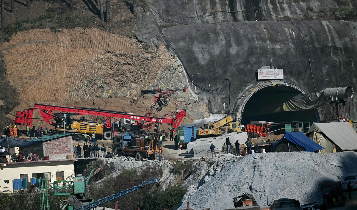 Rescue personnel move a digging machine during rescue operation for workers trapped in the Silkyara under construction road tunnel, days after it collapsed in the Uttarkashi district of India's Uttarakhand state on November 25, 2023. (AFP)