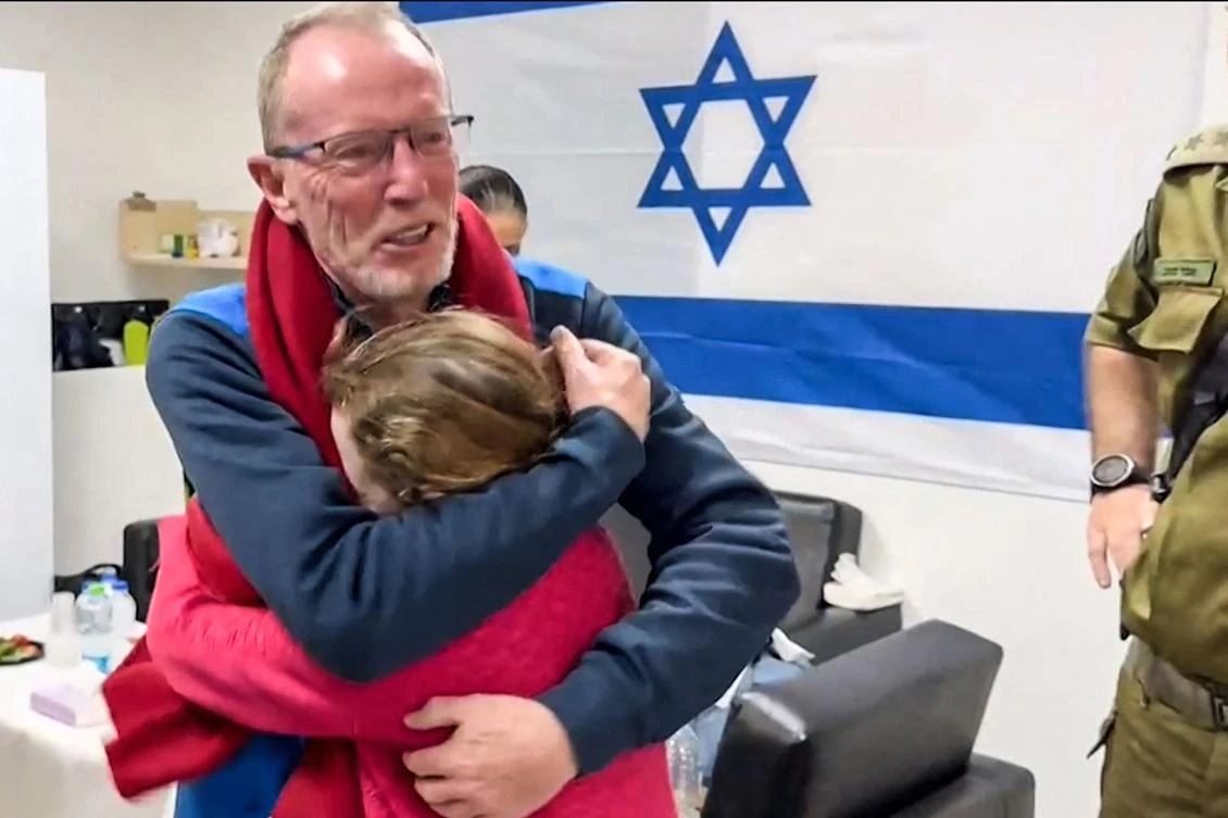 A handout video released by the Israeli army, shows 9-year-old Irish Israeli former hostage Emily Hand embracing her father at a hospital in Israel after being released by Hamas. (AFP)