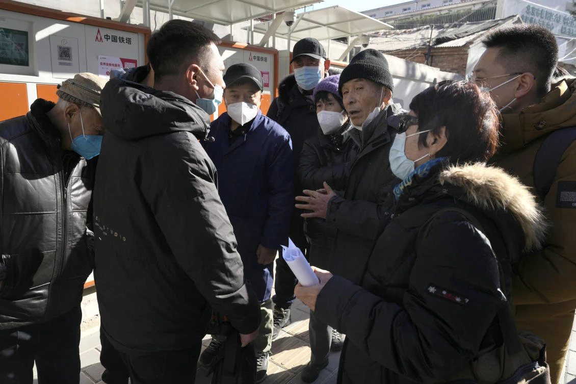 The families of more than 110 other passengers on the missing Malaysian Airline MH370 have already reached a settlement and received between 2.5 million and 3 million yuan. Above, relatives listen to another who just attended his compensation hearings in Beijing on Nov. 27, 2023. (AP)