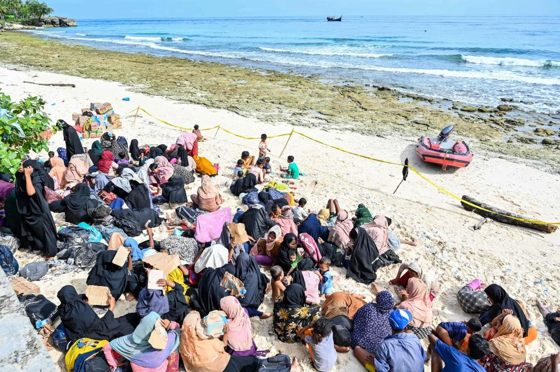 Newly-arrived Rohingya refugees rest on a beach in Sabang island, Aceh province on Nov. 22, 2023 as they escape violence and brutality in Bangladesh camps. (AFP)