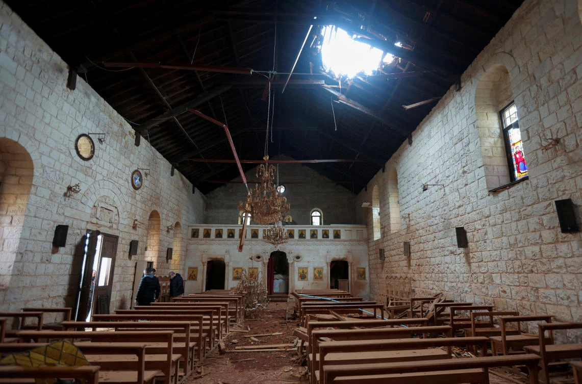 Men work inside Saint George church that was damaged during Israeli shelling in recent weeks prior to a truce taking hold between Hamas and Israel that has informally extended to southern Lebanon, in Yaroun, on Nov. 28, 2023. (Reuters)