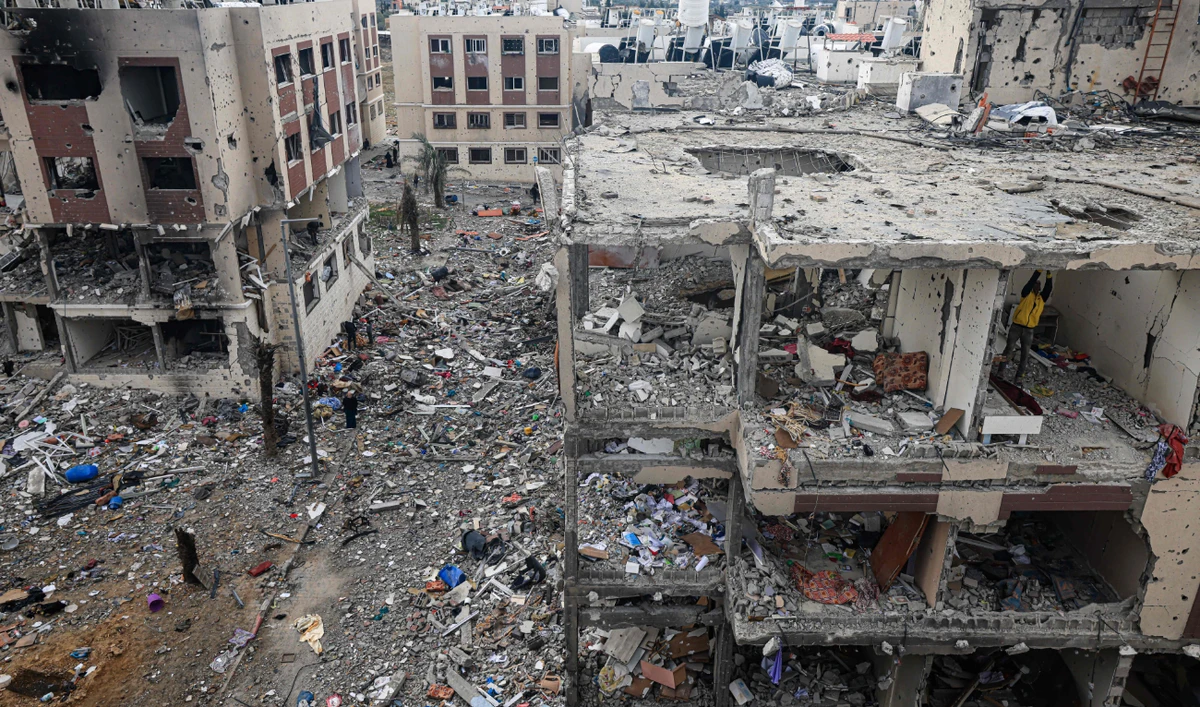 Palestinians inspect the destruction caused by Israeli strikes in Wadi Gaza, central Gaza strip. some buildings in the besieged enclave have been reduced to piles of broken concrete and metal rods. (AFP)