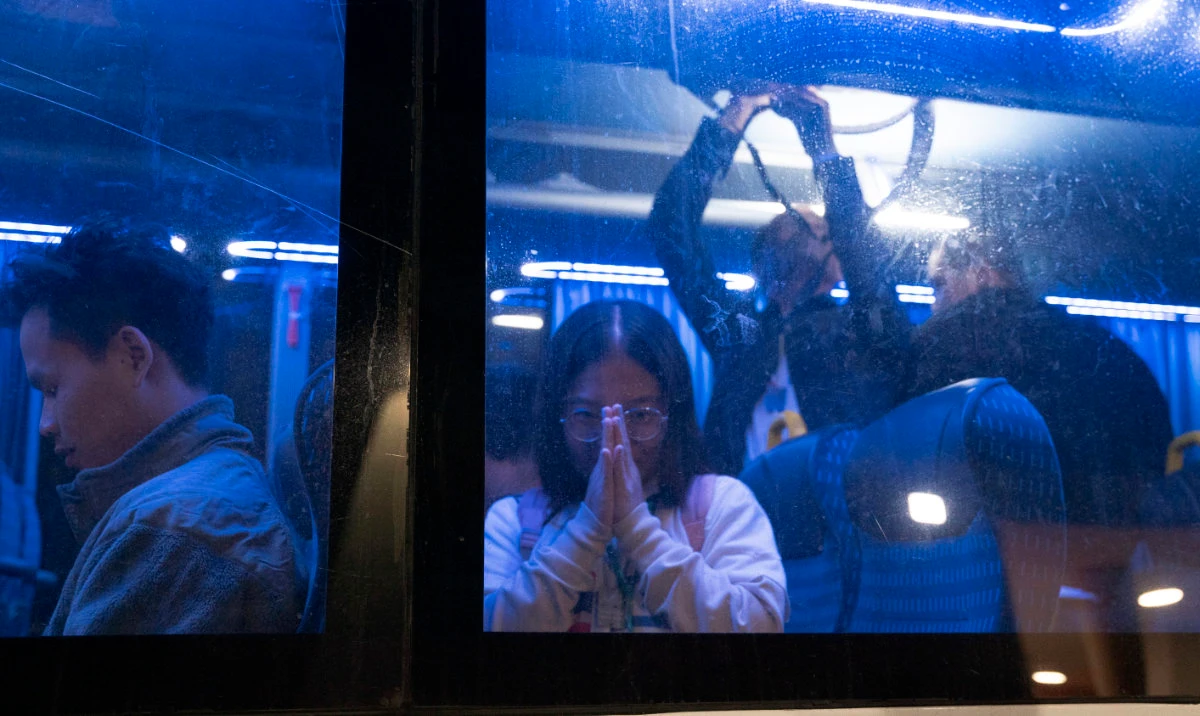 Thai nationals gesture from a bus as they leave the Shamir Hospital in Ramle, Israel, Wednesday, Nov. 29, 2023, on their way back to Thailand, after being released from Hamas custody. (AP)