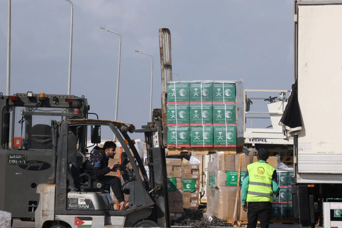 Workers unload humanitarian aid destined for the Gaza Strip via Rafah border area, during a temporary truce between Hamas and Israel, at Al Arish airport, Egypt, on Nov. 27, 2023. (Reuters)