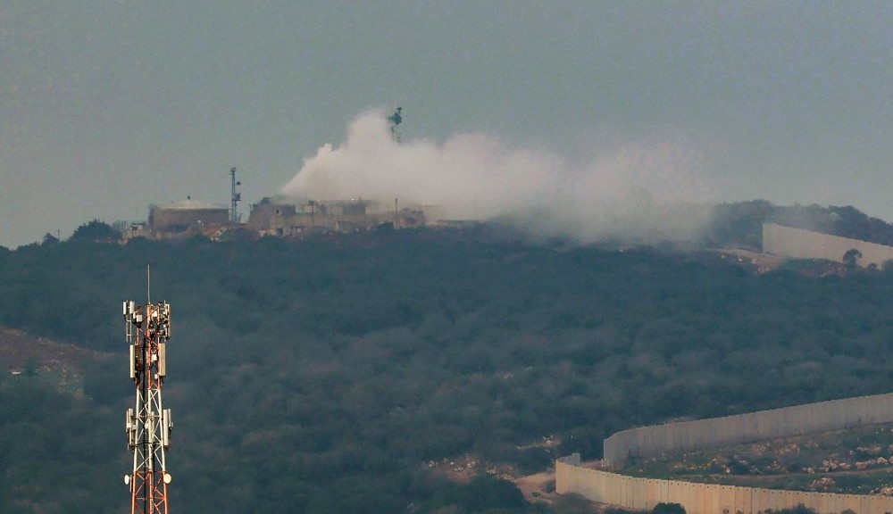 Smoke billows from a Israeli army post after it was hit by a rocket fired from Lebanon, Dec. 12, 2023. (AFP)
