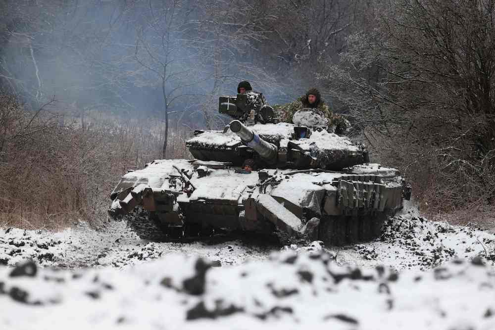 Above, Ukrainian soldiers drive a tank in a position near to the town of Bakhmut, Donetsk region on Dec. 13, 2023. (AFP)
