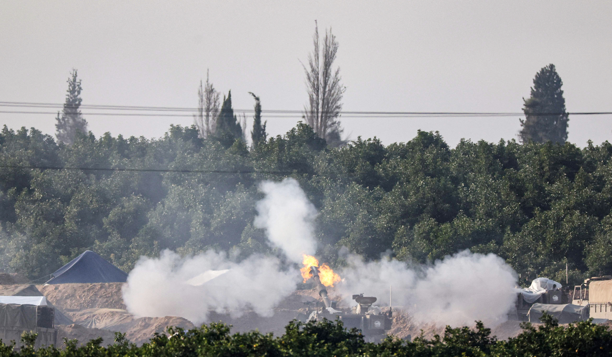 An Israeli tank firing towards the Palestinian territory amid continuing battles between Israel and the militant group Hamas.