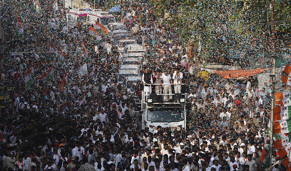 India's Congress party leader Rahul Gandhi along with Priyanka Gandhi Vadra greet supporters as they arrive for an election campaign rally in Hyderabad, India, on November 28, 2023. (AP)