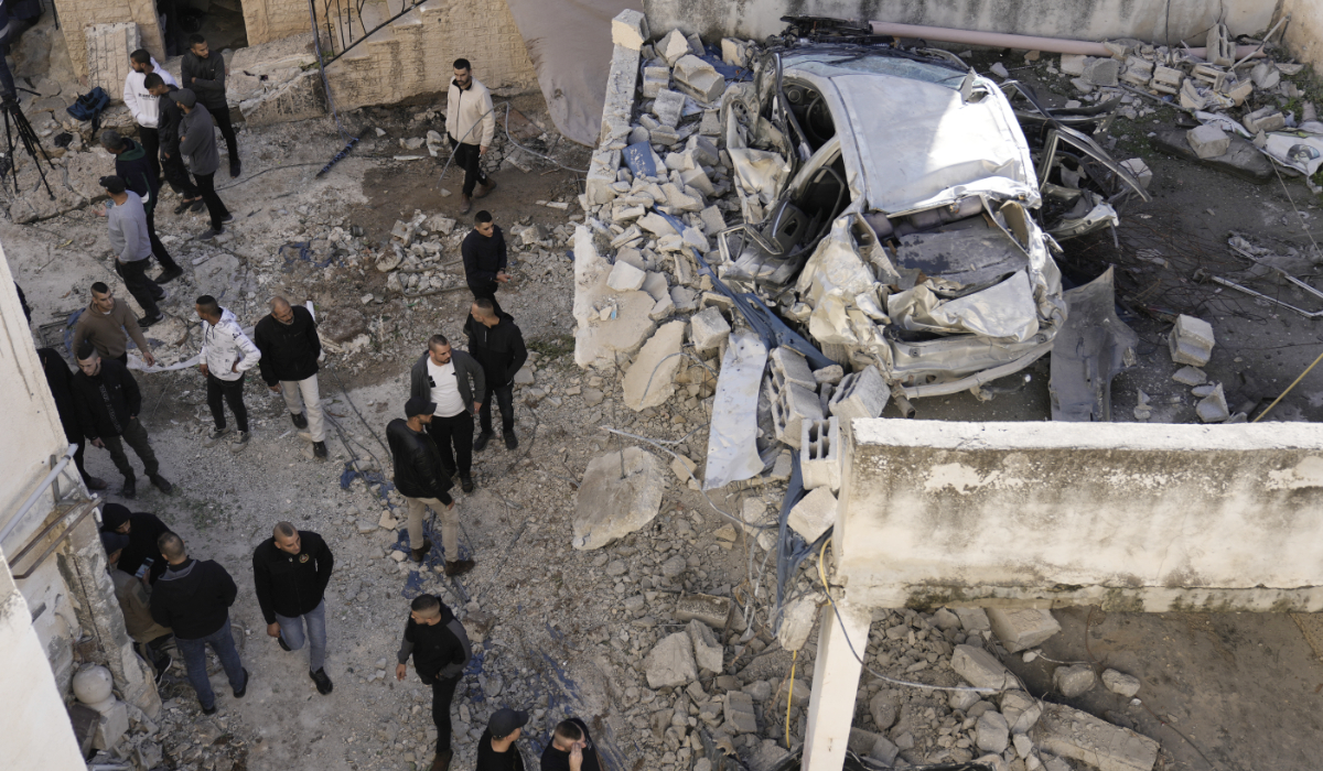 Palestinians look at the aftermath of an Israeli military raid on Jenin refugee camp in the West Bank on Wednesday, Nov. 29, 2023. (AP)