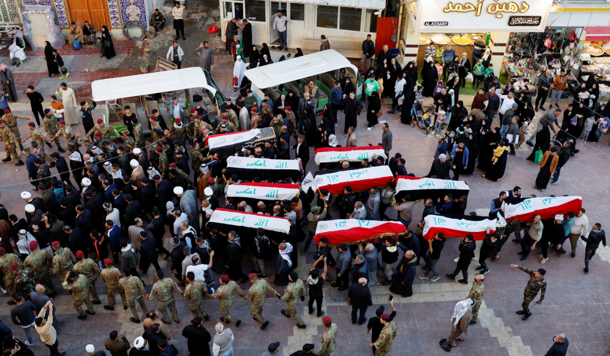 Mourners carry the coffins of victims, who were killed in an attack in Iraq's eastern Diyala province, during a funeral in Najaf, Iraq, December 1, 2023. (REUTERS)