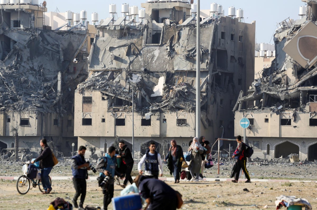 Buildings lie in ruin as Palestinians carry their belongings following Israeli strikes on residential buildings at the Qatari-funded Hamad City, amid the ongoing conflict between Israel and the Palestinian Islamist group Hamas, in Khan Younis in the southern Gaza Strip December 2, 2023. (REUTERS)