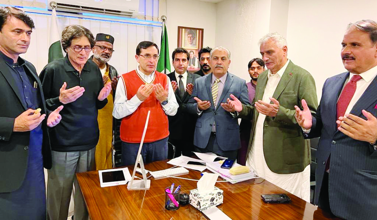 Gohar Khan, in orange sweater, visited the Pakistan Tehreek-e-Insaaf’s central office in Islamabad after his election as the party’s chairman. (Photo/Twitter)