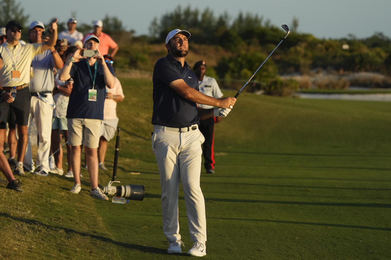Scottie Scheffler, of the US, watches his fairway shot on the 18th hole during the third round of the Hero World Challenge PGA Tour at the Albany Golf Club, in New Providence, Bahamas, on Saturday. (AP)