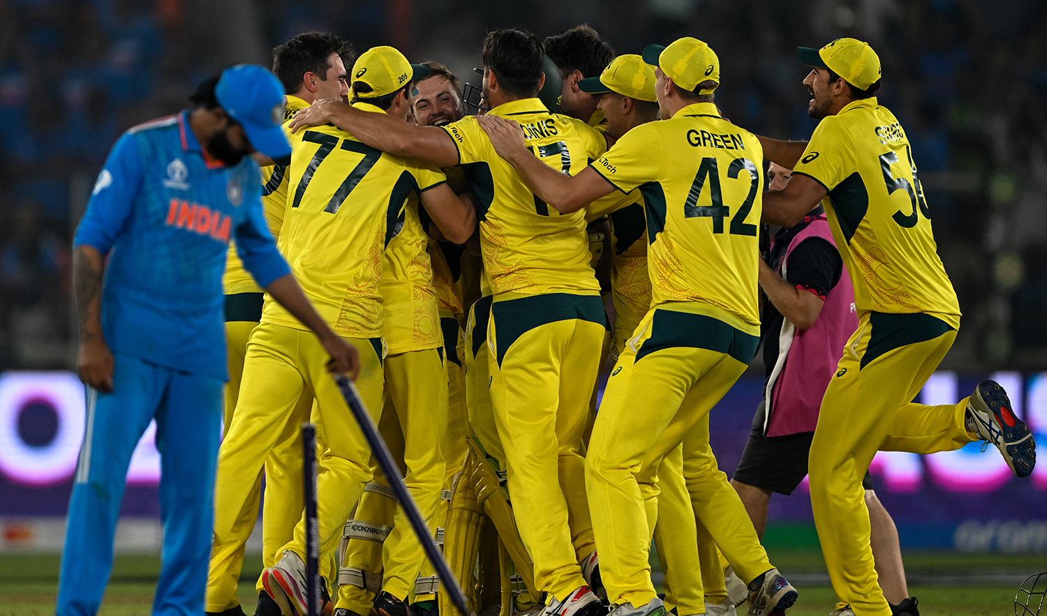India's Ravindra Jadeja holds the stumps past Australia’s players celebrating their win in the 2023 ICC Men's Cricket World Cup one-day international (ODI) final match at the Narendra Modi Stadium in Ahmedabad, India on November 19, 2023. (AFP/File)