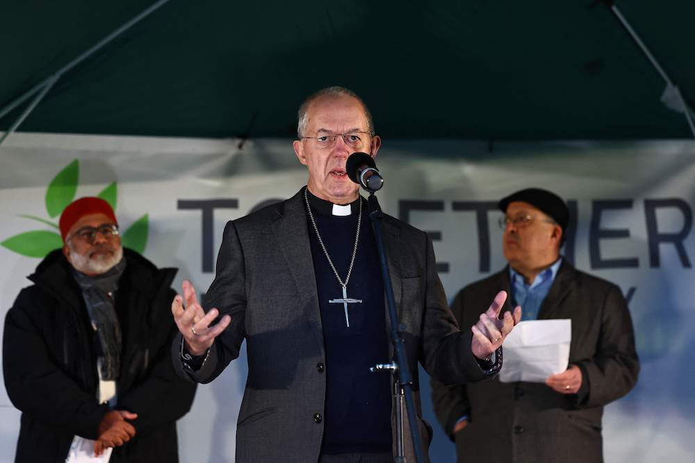 Archbishop of Canterbury Justin Welby delivers a speech next to Imam Monawar Hussain and Rabbi David Mason (R) during the “Building Bridges, Together for Humanity” vigil to “give a voice to the majority of the public who stand against hate” in central London on December 3, 2023. (AFP)