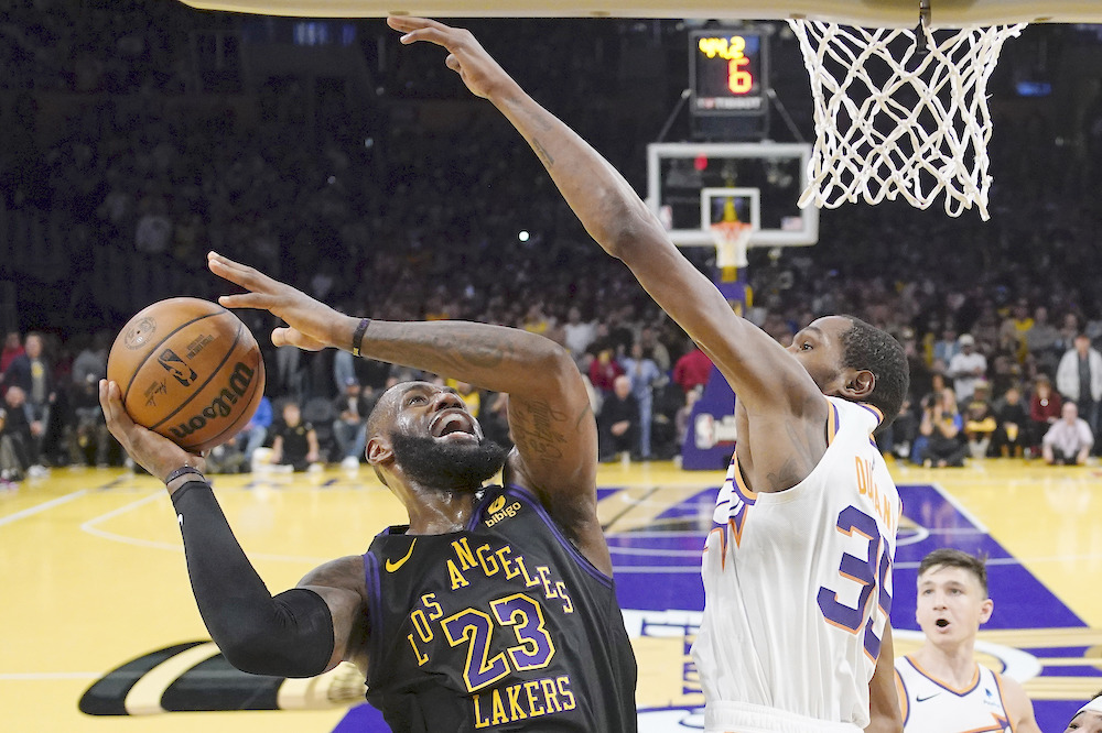 Los Angeles Lakers’ LeBron James shoots against Phoenix Suns’ Kevin Durant during their NBA basketball In-Season Tournament quarterfinal game Tuesday in Los Angeles. (AP)