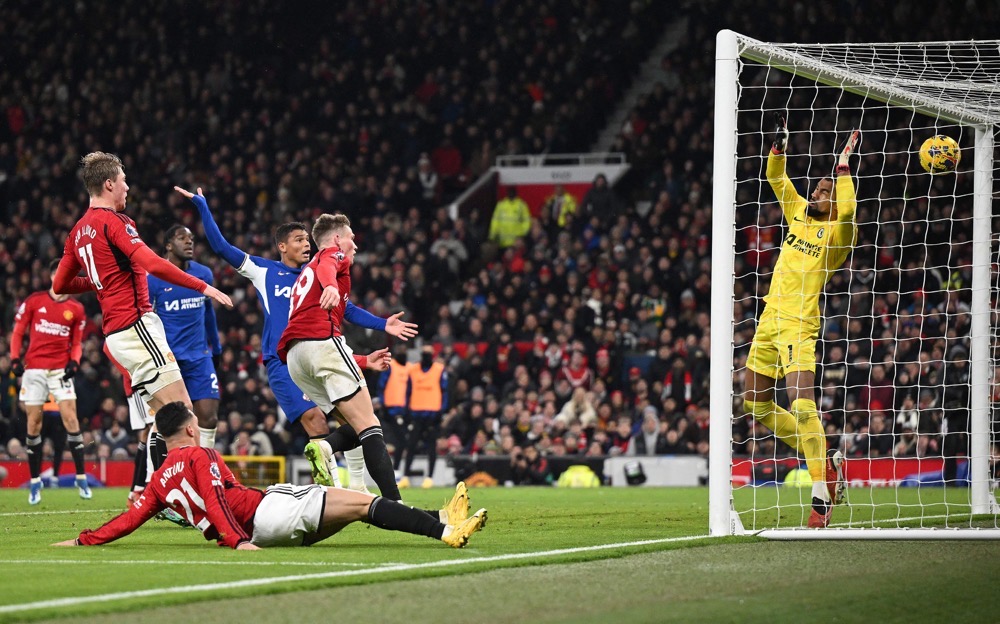 Manchester United's Scottish midfielder Scott McTominay (C) watches his header pass Chelsea's Spanish goalkeeper Robert Sanchez to score the team's second goal during their English Premier League football match at Old Trafford in Manchester, north west England, on Dec. 6, 2023. (AFP)