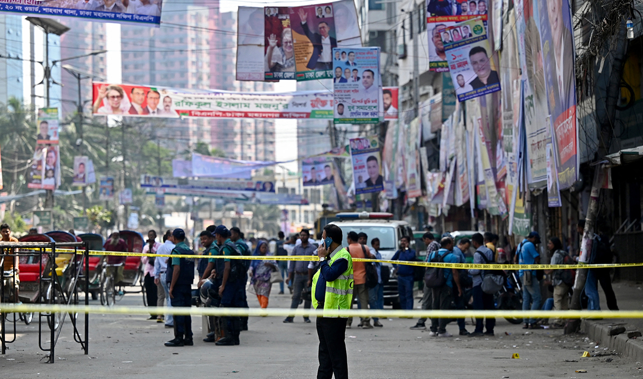 Bangladesh's Criminal Investigation Department (CID) member attends a phone call as he inspects a protest site after Bangladesh Nationalist party (BNP) activists held a rally amid the ongoing nationwide strike in Dhaka on October 29, 2023. (AFP/File)