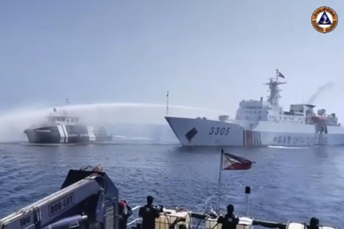 A Chinese Coast Guard ship, right, uses a water cannon on a Philippine Bureau of Fisheries and Aquatic Resources vessel as it approaches Scarborough Shoal in the disputed South China Sea on Dec. 9, 2023. (Philippine Coast Guard via AP)