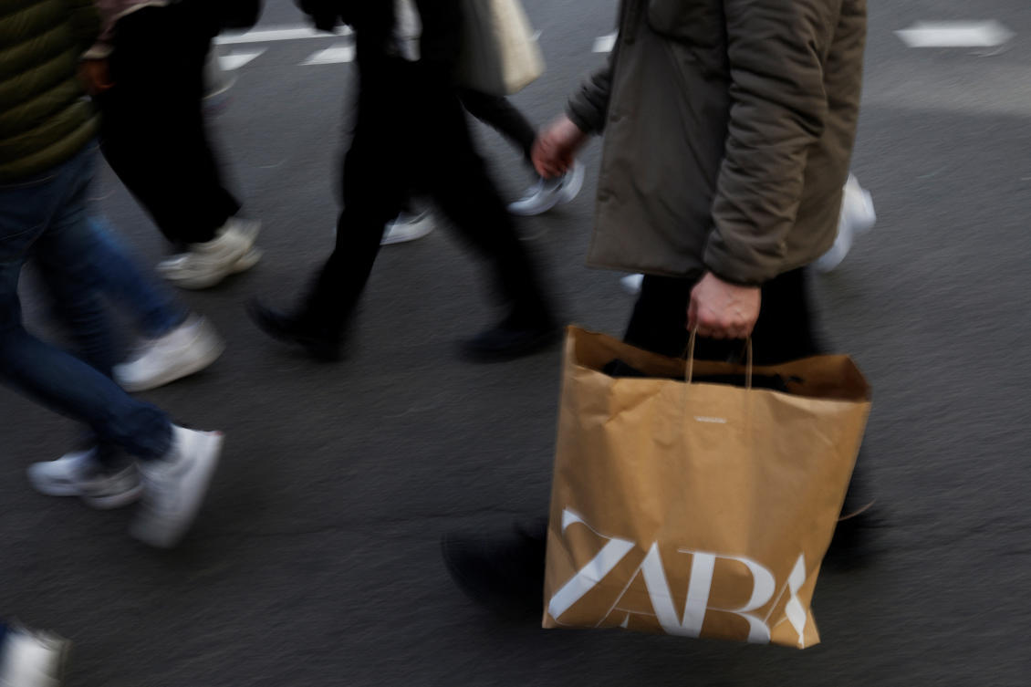 A man walks with a Zara bag in central Madrid, Spain, December 11, 2023. (Reuters)
