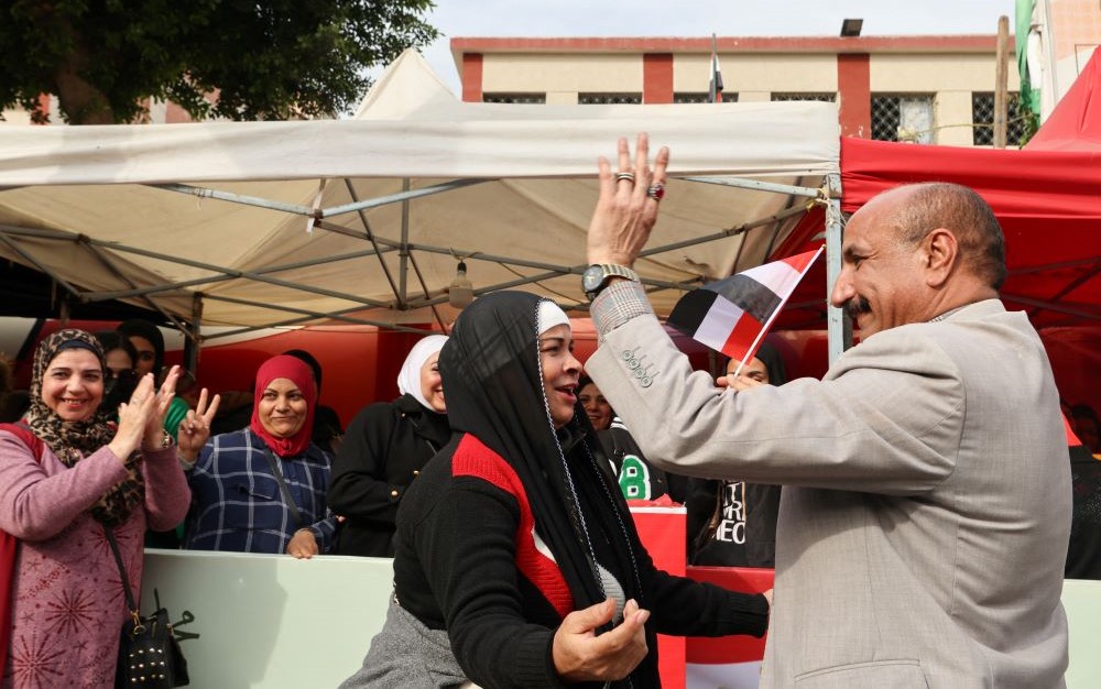 Supporters of presidential candidate and Egyptian President Abdel Fattah El-Sisi dance next to a polling station on the first day of the presidential election in Cairo, Egypt, Dec. 10, 2023. (Reuters)