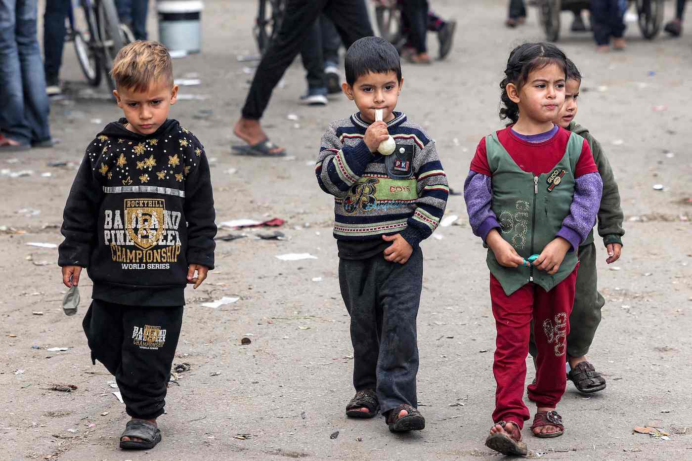 Children walk along a street in Rafah in the southern Gaza Strip on Dec. 12, 2023, amid continuing battles between Israel and Hamas. (AFP)