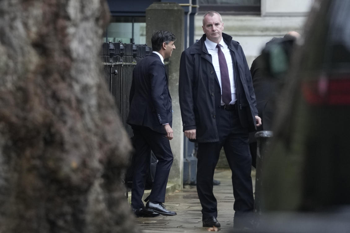 Britain’s Prime Minister Rishi Sunak, left, leaves Downing Street to go to Parliament in London, Tuesday, Dec. 12, 2023. (AP Photo)