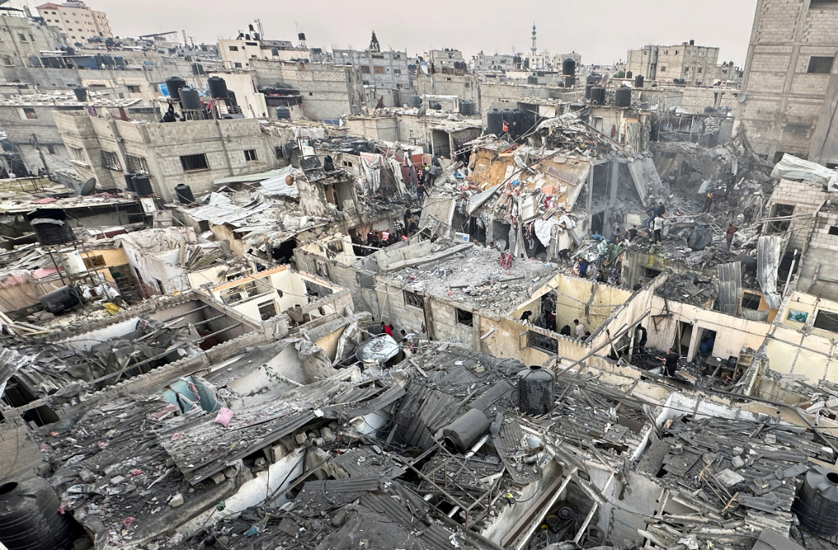 People search through the rubble of damaged buildings following an Israeli air strike on Palestinian houses, amid the ongoing conflict between Israel and the Palestinian Islamist group Hamas, in Rafah in the southern Gaza Strip December 12, 2023. (REUTERS)