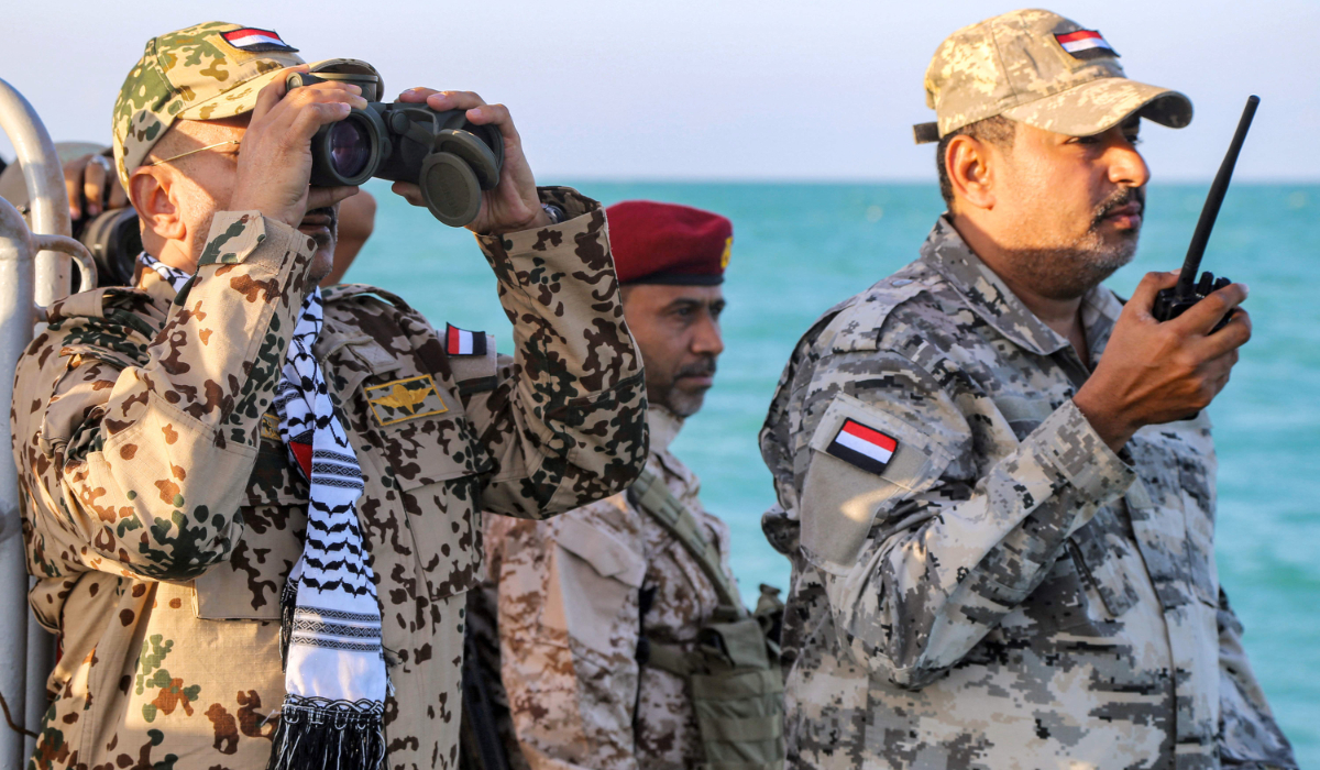 Brigadier General Tariq Muhammad Abdullah Saleh (L), member of the Presidential Leadership Council in Yemen's internationally-recognised government, looks through binoculars as he observes coastguard members patrolling in the Red Sea off of the government-held town of Mokha in the western Taiz province, close to the strategic Bab al-Mandab Strait, on December 12, 2023. (AFP)