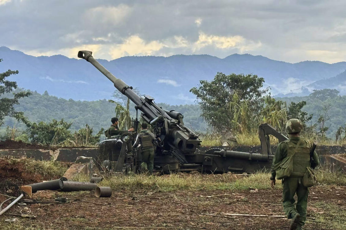 Members of an ethnic armed forces group check weapons the group allegedly seized from Myanmar’s army outpost on a hill in Hsenwi township in Shan state on Nov. 24, 2023. (The Kokang online media via AP)