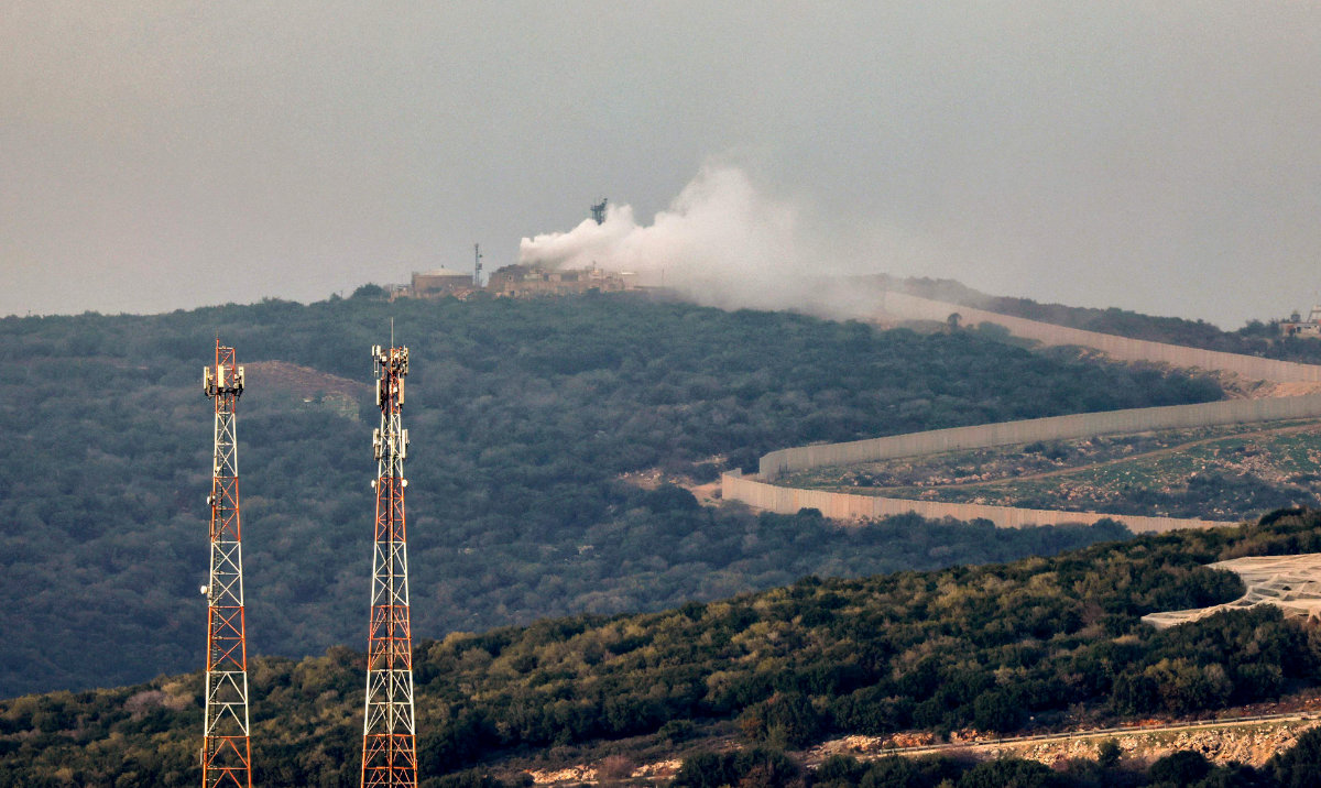 Smoke billows from a Israeli army post on the border with Lebanon after it was hit by a rocket fired from Lebanon on December 12 , 2023, amid increasing cross-border tensions as fighting continues with Hamas militants in the southern Gaza Strip. (AFP)