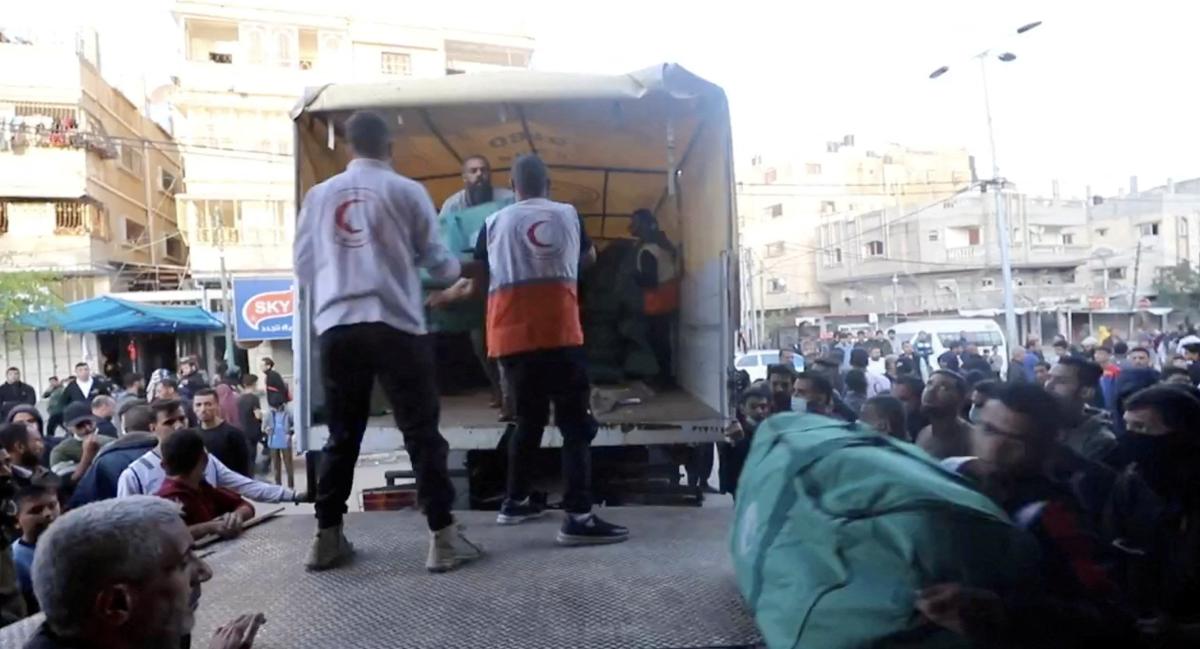 Palestinian Red Crescent workers transport aid, amid the ongoing conflict between Israel and Hamas, in Khan Younis, Gaza. (Reuters)