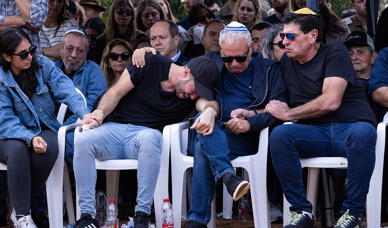 Relatives and friends, including the father Avi (2nd-R), mourn as they gather for the funeral of Alon Shamriz, mistakenly killed by Israeli forces in Gaza on December 17, 2023. (AFP)