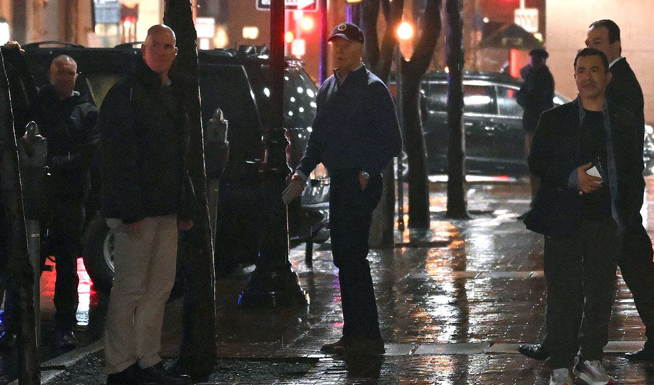 US President Joe Biden (C) looks on after a car hit an SUV in the motorcade as he left his campaign headquarters in Wilmington, Delaware on December 17, 2023. (AFP)