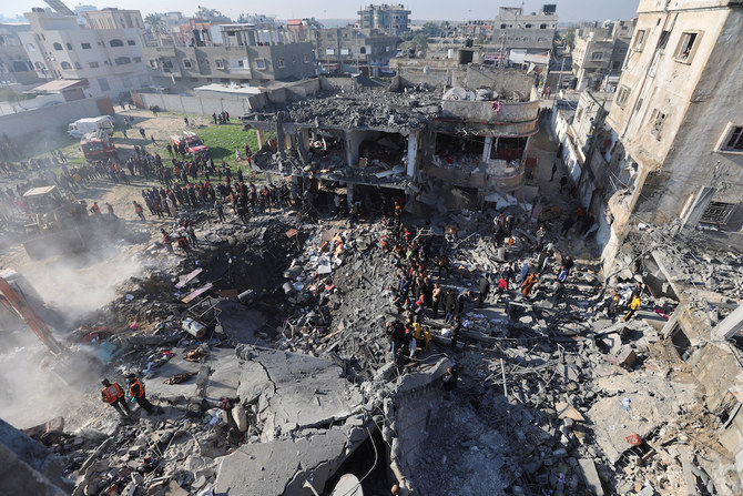 Palestinians gather at the site of an Israeli strike on a house in Rafah in the southern Gaza Strip on December 19, 2023. (REUTERS)