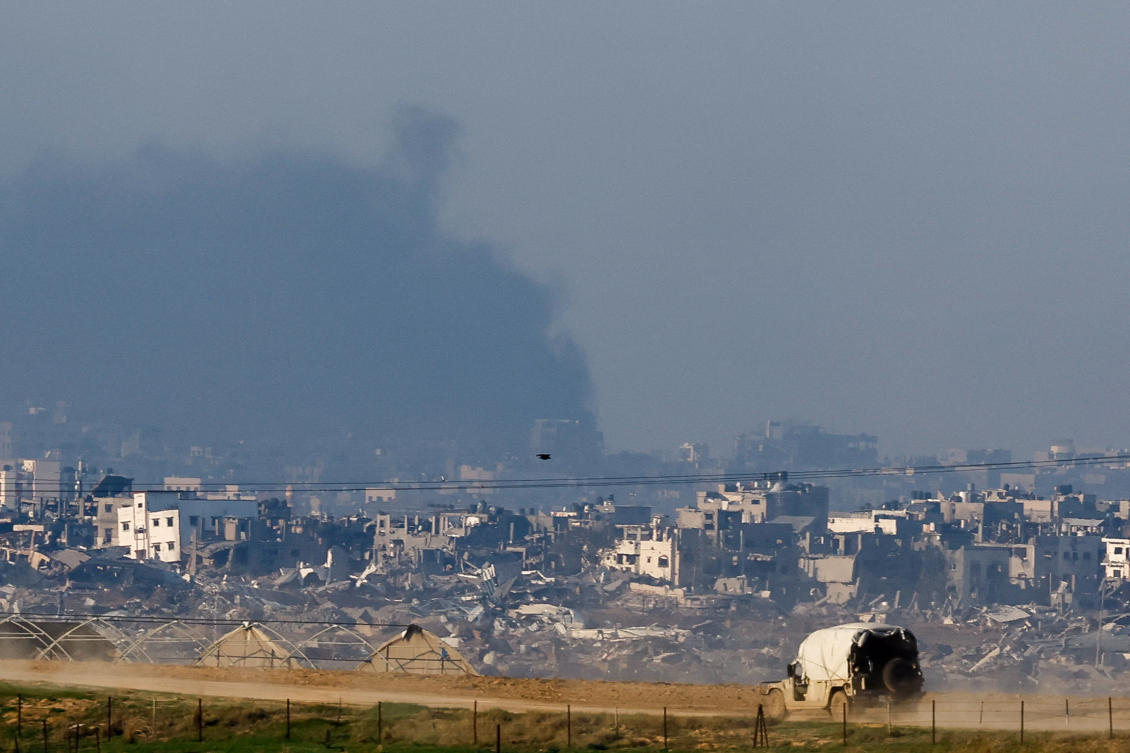 An Israeli military vehicle drives near damaged buildings in the Gaza Strip, amid the ongoing conflict between Israel and Hamas, on Dec. 19, 2023. (Reuters)