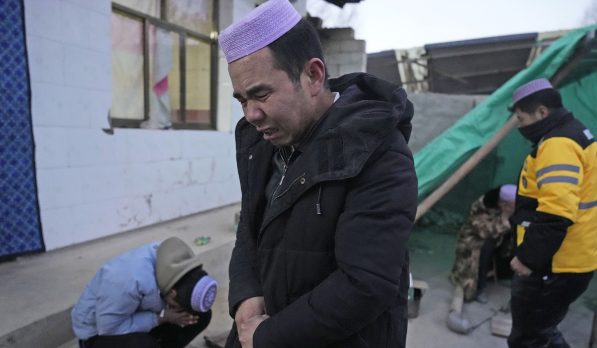 Ma Lianqiang grieves for his wife who was killed in the earthquake in Yangwa village near Dahejia town in northwestern China's Gansu province, Wednesday, Dec. 20, 2023. (AP)