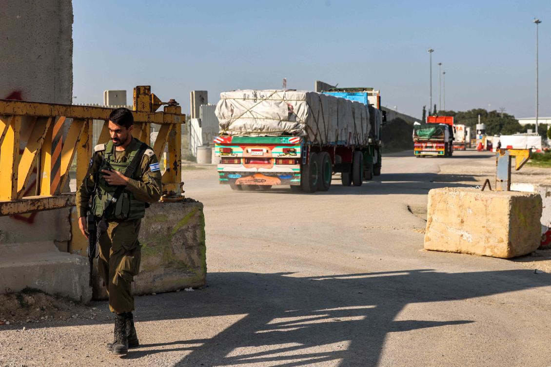 Trucks carrying humanitarian aid move at the Israeli side of the Kerem Shalom border crossing with the southern Gaza Strip on Dec. 19, 2023. (AFP)